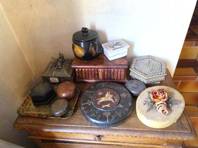 a small table with a clock, books, and other items on it