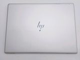 the back of a laptop computer sitting on top of a white table