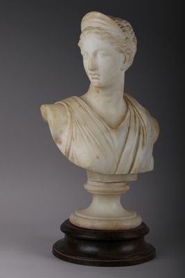a white marble bust of a woman on a pedestal