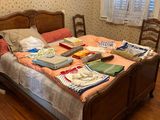 a bed that has many items on it in the room