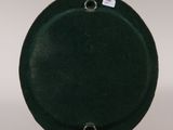 pair of black ceramic plates with metal bases on a white surface