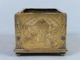 an antique brass box with a design on the front