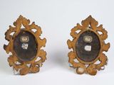 pair of antique wooden picture frames on stand on white background