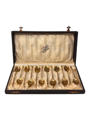 six spoons in a case that are in the shape of spoons