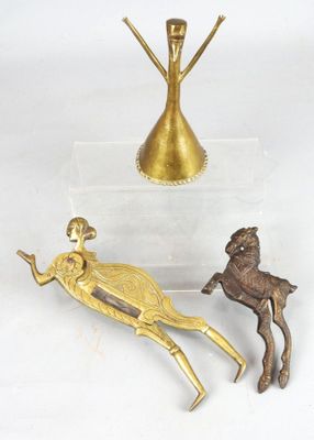 a gold statue of a woman and a deer next to a gold vase