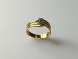 a close up of a gold ring with a diamond on it