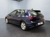 the back end of a blue vw passat parked in a showroom