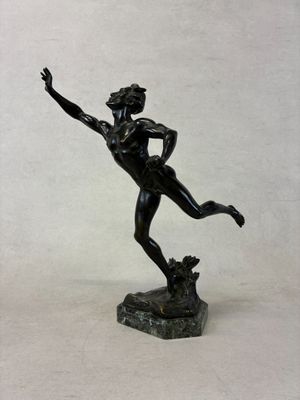 statue of a man holding a frisbee in his right hand