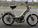 a small motor bike that is parked on the side of the road