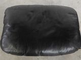 black leather seat cushion on the floor of a car