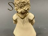 an image of a small figurine of a girl with a white dress