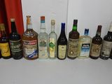many bottles of alcohol lined up on the counter