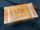 a small wooden box with a flower design on it