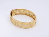 a close up of a gold ring on a white surface