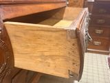 a wooden dresser with a drawer in the middle of it