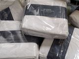 a pile of white blankets sitting on top of each other