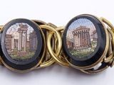 a picture of a bracelet with a picture of a roman temple on it