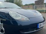 a picture of a blue sports car parked in a parking lot