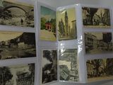 a bunch of old postcards on display on a table