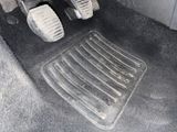 a close up of a car ' s floor with pedals
