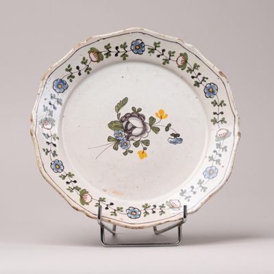 a white plate with blue and yellow flowers on it