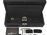 an image of a watch in a black box with its contents in it