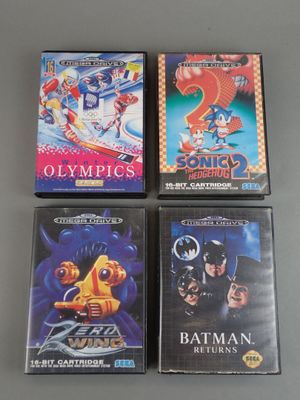 three nintendo games are on a table with a gray background