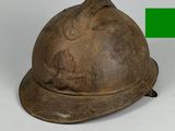 un vieux casque sur lequel pointe une flèche verte