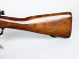 an old wooden rifle on a white surface with a white background