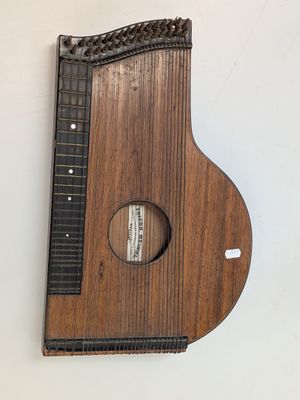 a wooden instrument that is hanging on the wall