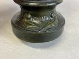 a small bronze statue of a woman holding a bird