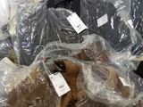 a pile of stuffed animals that are wrapped in plastic