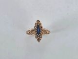 a close up of a gold ring with a blue stone in it