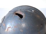 a close up of a helmet with a hole in it
