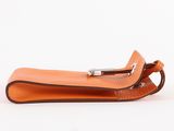 an orange leather case with a metal clasp on a white background