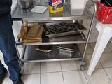 a man that is standing in a kitchen near a table
