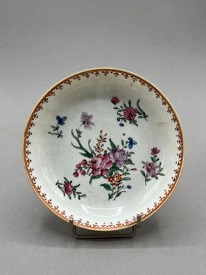 an image of a plate with flowers on it on a stand