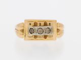 a close up of a gold ring with a diamond in the center