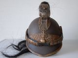 a helmet with a long black hair on a table