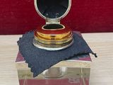 a small silver box with a black cloth on it
