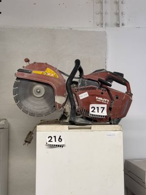 a chainsaw sitting on top of a refrigerator in a room
