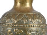 a gold vase with a floral design on it