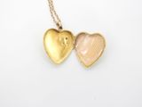 a close up of a heart shaped locke on a chain