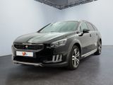 the black car is parked in a large room with white walls