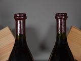 two bottles of wine sitting next to each other on a table