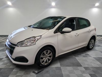 the small white car is parked in a large room