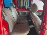 a red van with two seats in the back of it