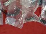 many pieces of plastic wrapped up on a red surface