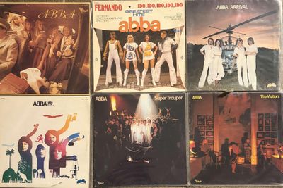 many different album covers on the table