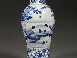 blue and white porcelain vase with a landscape scene on it
